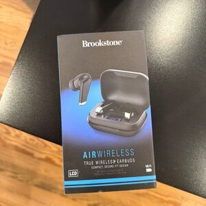 New black Brookstone air wireless earbuds, in box